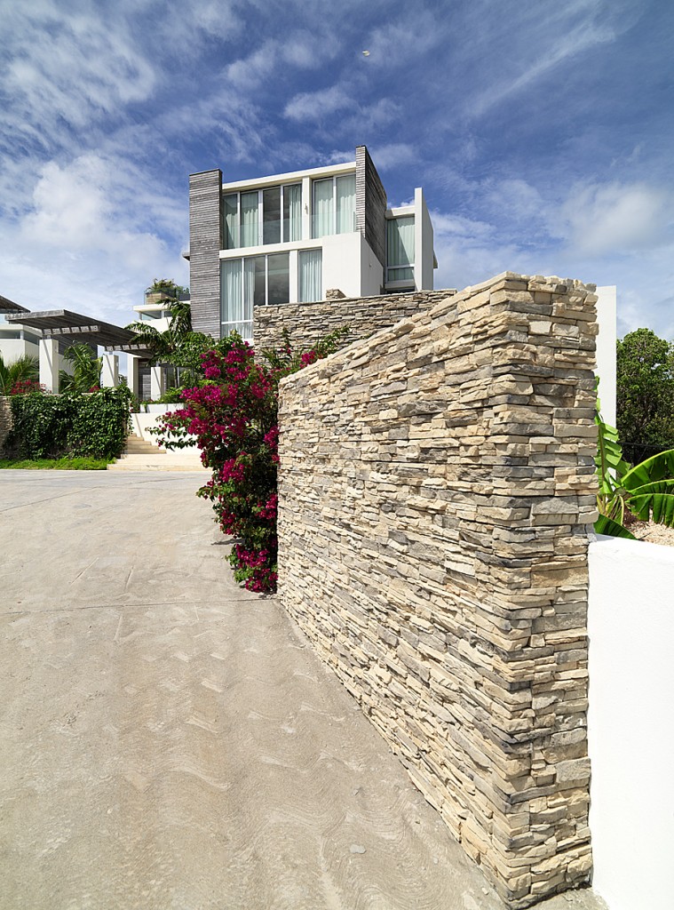 Stone flank walls leading to the entrance forecourt