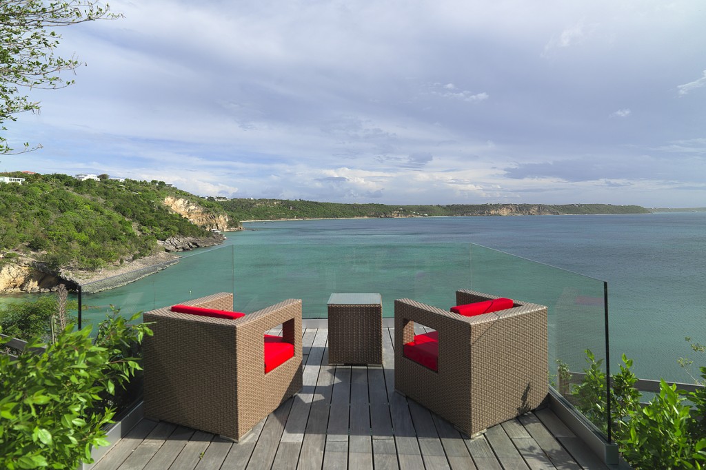 The ultimate view from glass enclosed deck cantilevered  off the edge of the bluff overlooking the Caribbean