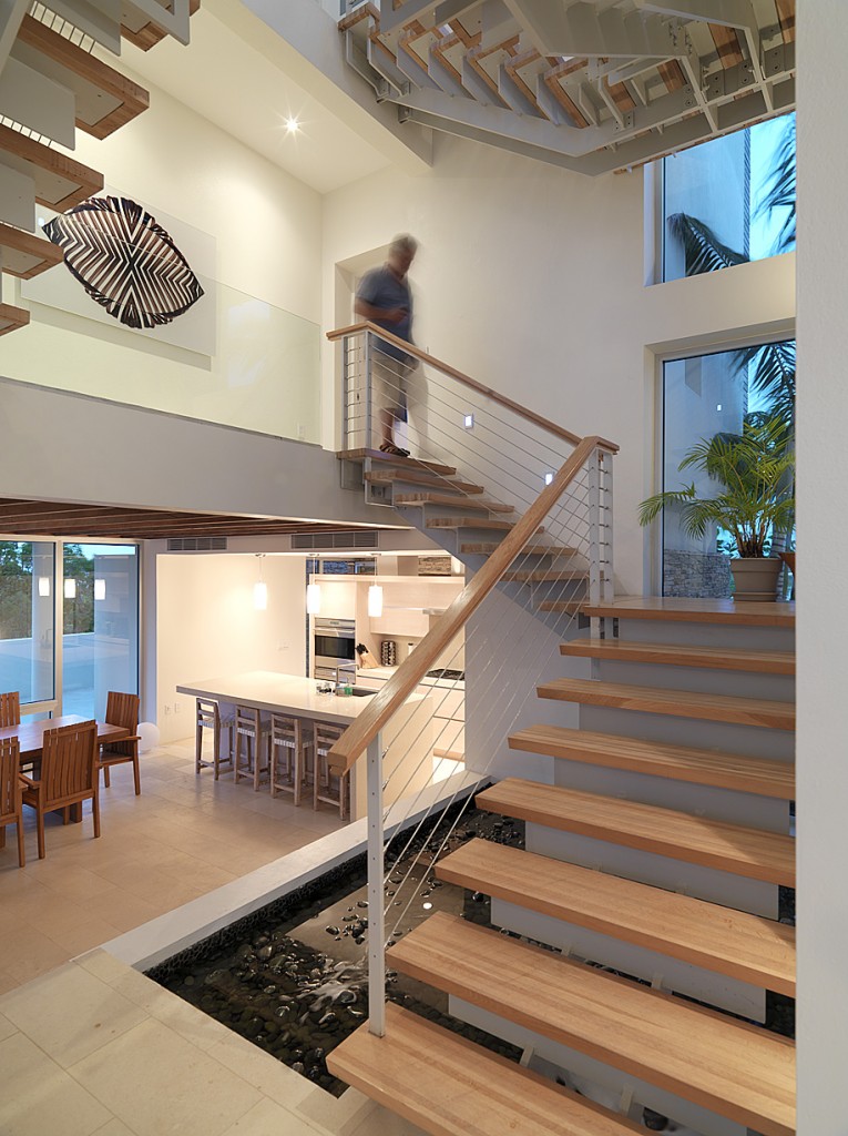 The stair well with kitchen and dining room at the lower level